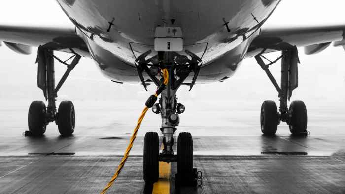 gray-air-vehicle-with-yellow-coated-cable-around-docking-2315265