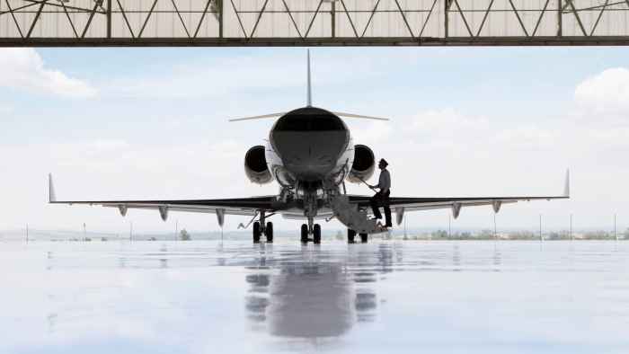 airline-pilot-standing-next-to-a-private-jet-2026