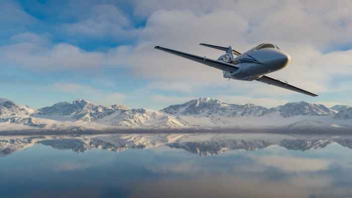 corporate-jet-flying-over-mountain-reflecting (1)