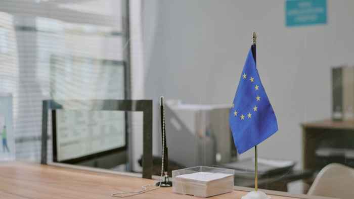 eu-flag-and-stationery-on-wooden-reception-desk