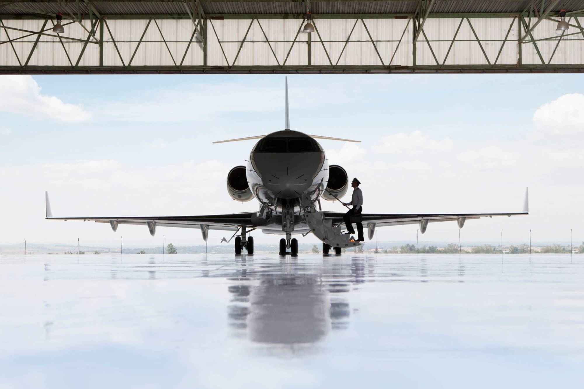 airline-pilot-standing-next-to-a-private-jet-2026