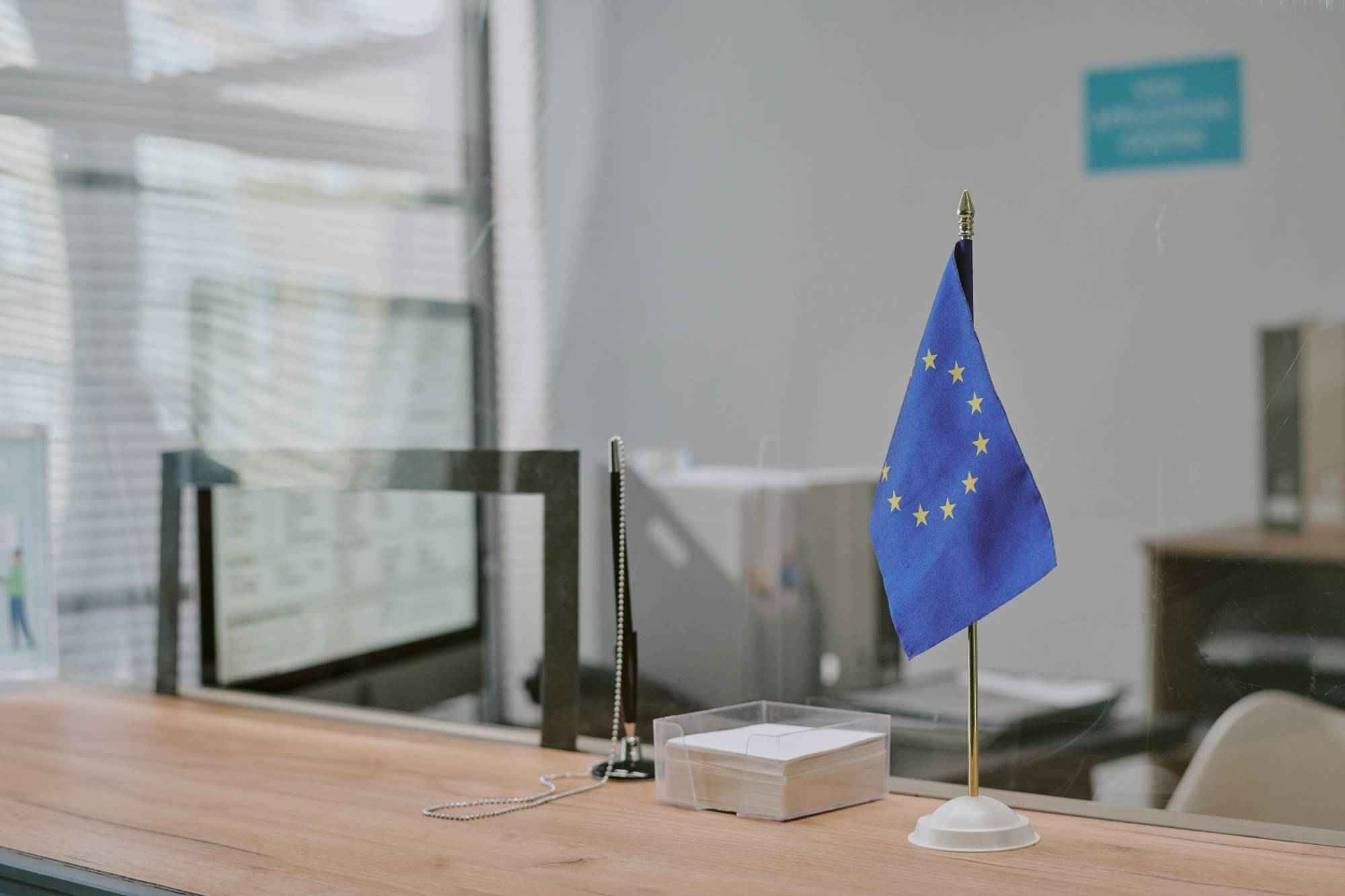 eu-flag-and-stationery-on-wooden-reception-desk