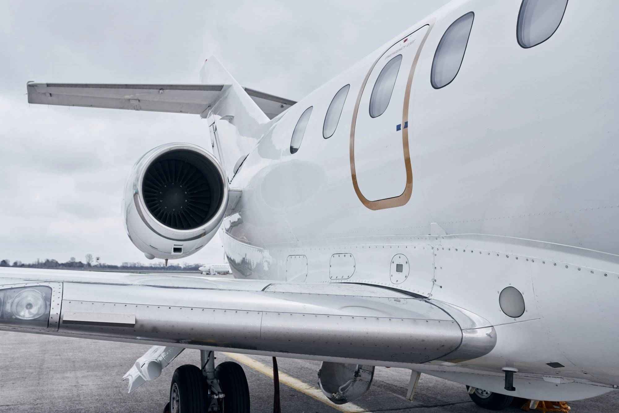 private-jet-engine-and-wing-closeup-on-tarmac