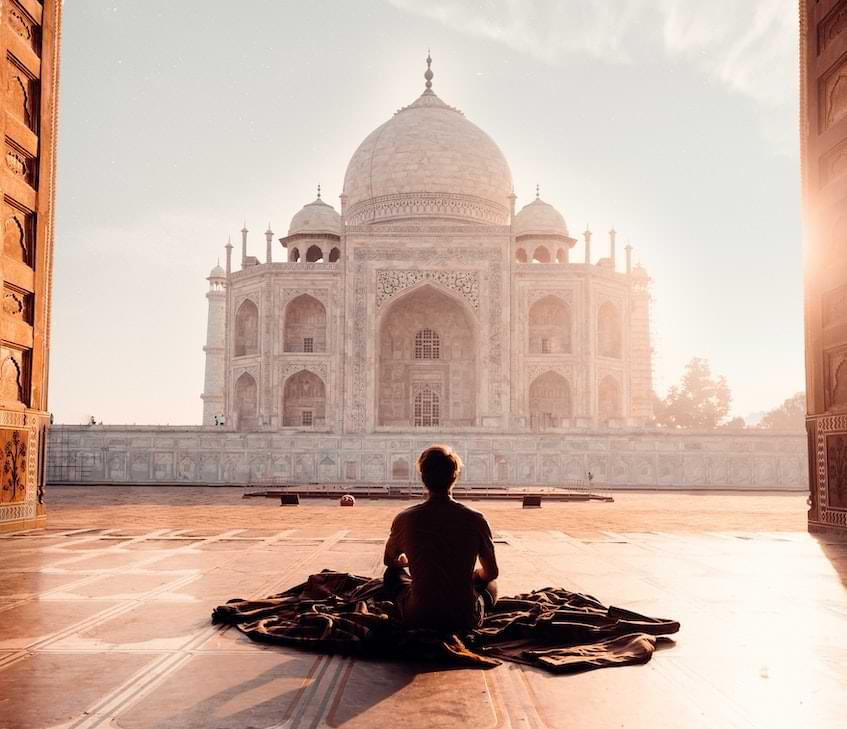 Person sitting in front of Taj Mahal, India