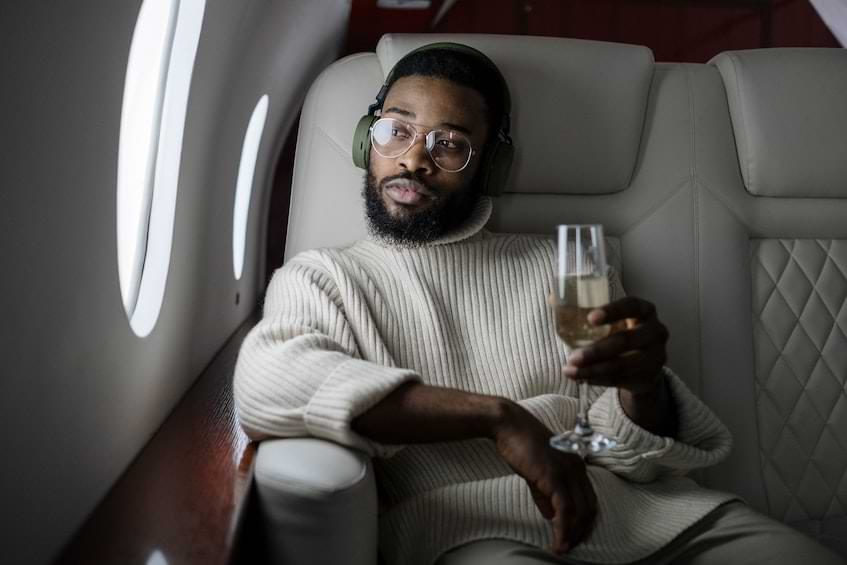 man on a private jet drinking champagne