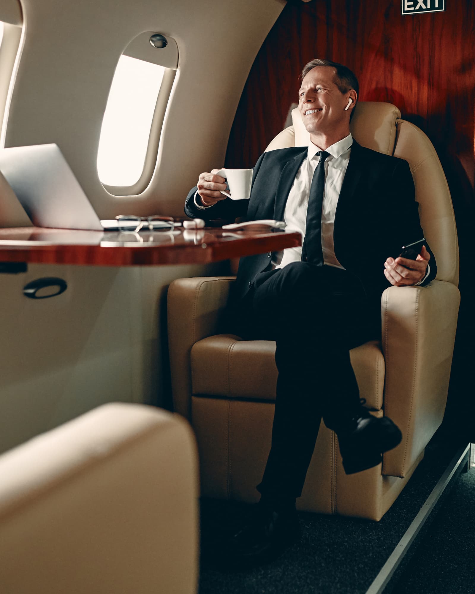 Passenger boarding a private jet at sunset