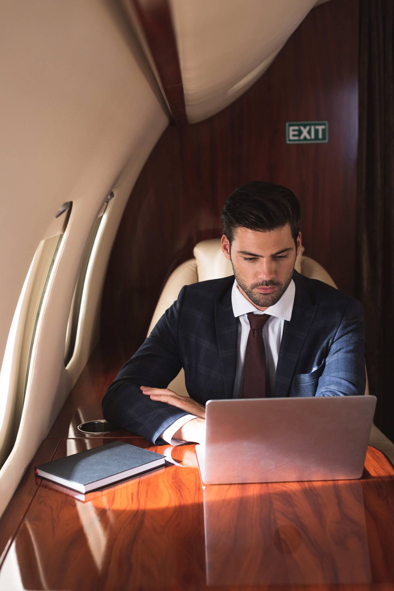 Passenger boarding a private jet at sunset